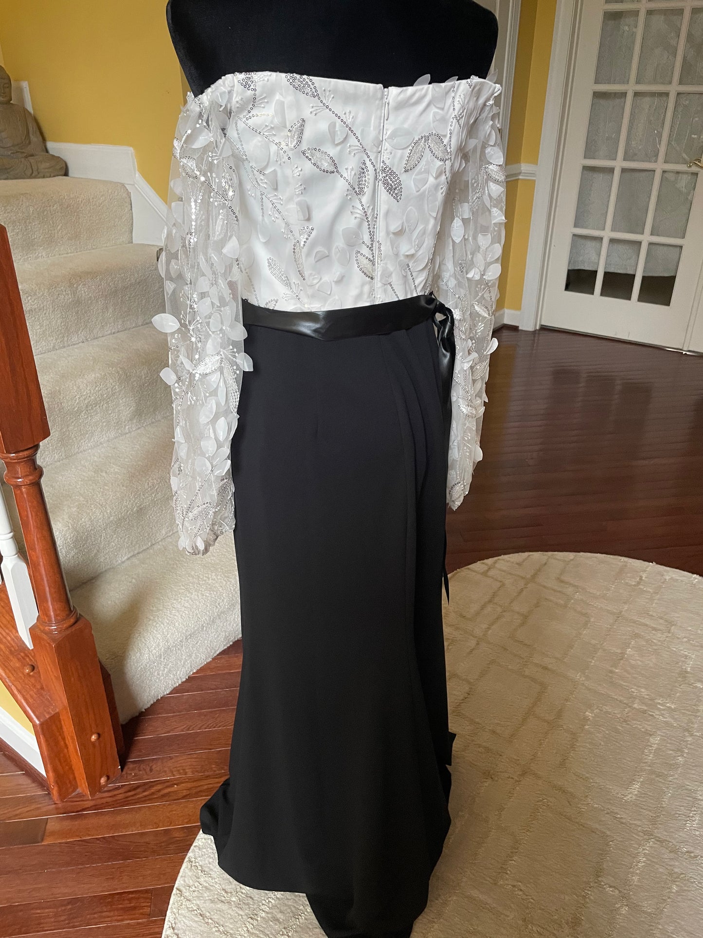 0726 SIZE:8 ELIZA J BLACK&WHITE FLOATING PETALS LNG SLV GOWN W/LEAF APPLIQUE & SILVER SEQUIN SHEER SLVS AND WHITE BODICE, GATHERED SHOULDERS, CONCEALED BACK ZIPPER, LNG BLACK SKIRT, AND SATIN BELT NWOT RTL:$188.00